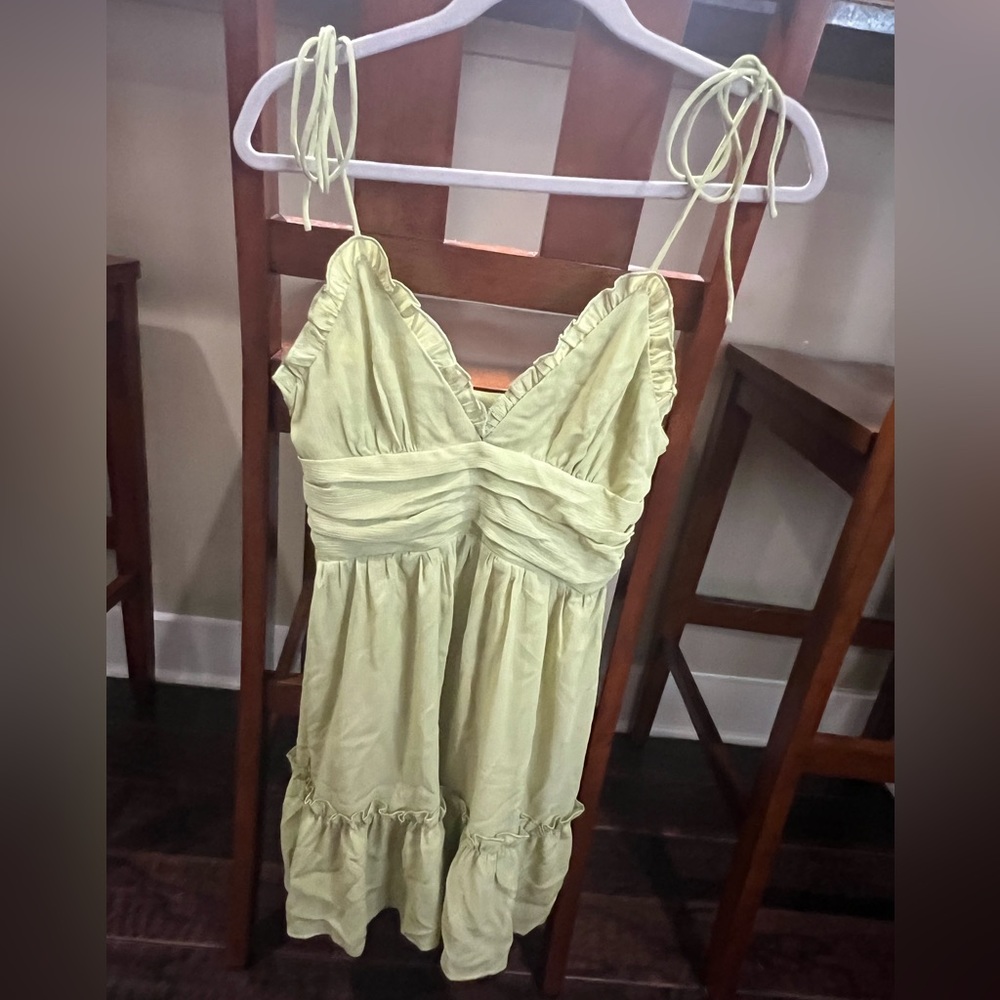 green fit and flare mini dress with adjustable ties on the shoulder